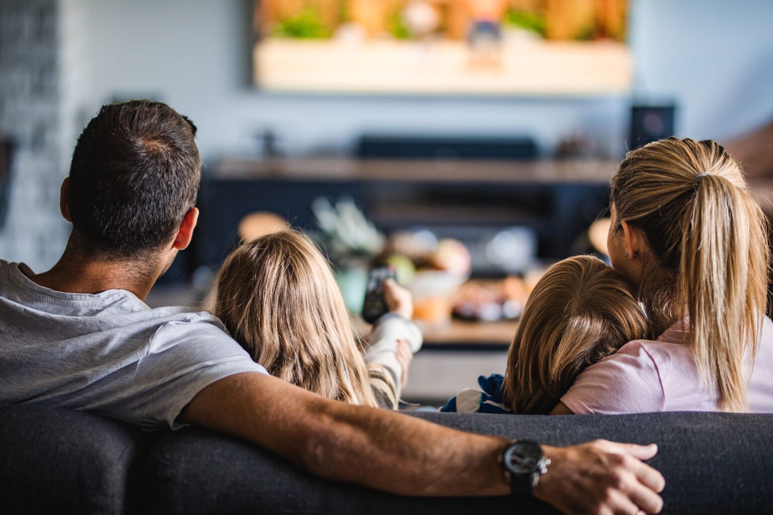 Family Watching Movie In Living Room